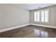 Bedroom with hardwood floors and natural light from the window at 11760 Stratham Dr, Alpharetta, GA 30009