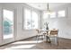 Bright breakfast nook with modern lighting and access to outdoor deck at 11760 Stratham Dr, Alpharetta, GA 30009