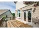 Outdoor wooden deck with brick wall detail, adjacent to a two-story house, perfect for relaxation at 11760 Stratham Dr, Alpharetta, GA 30009