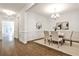 Bright dining room features hardwood floors, neutral decor, and wainscoting at 11760 Stratham Dr, Alpharetta, GA 30009