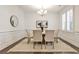 Dining room with modern chandelier, neutral rug, and decorative wall moulding at 11760 Stratham Dr, Alpharetta, GA 30009
