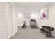 Bright exercise room with modern equipment, including a treadmill, stationary bike, and weight rack at 11760 Stratham Dr, Alpharetta, GA 30009