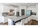 Modern kitchen boasts granite counters, stainless steel appliances, and breakfast bar seating at 11760 Stratham Dr, Alpharetta, GA 30009