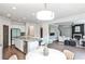 Modern open kitchen with granite countertops, stainless steel appliances, adjacent to living area at 11760 Stratham Dr, Alpharetta, GA 30009