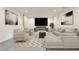 Spacious living room featuring contemporary decor, plush seating, and a large screen for entertainment at 11760 Stratham Dr, Alpharetta, GA 30009