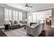 Bright living room featuring hardwood floors, large windows, elegant furnishings, and open layout at 11760 Stratham Dr, Alpharetta, GA 30009