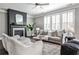Comfortable living room showcases a fireplace, plush seating, and shuttered windows at 11760 Stratham Dr, Alpharetta, GA 30009