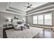 Spacious bedroom with tray ceiling, plush carpet, large windows, and stylish decor at 11760 Stratham Dr, Alpharetta, GA 30009