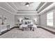 Spacious main bedroom features a tray ceiling, ceiling fan, and large windows with natural light at 11760 Stratham Dr, Alpharetta, GA 30009