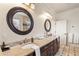 Bright bathroom featuring dual sinks, granite countertops, and stylish round mirrors at 629 Boulevard Ne, Atlanta, GA 30308