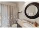 Cozy bathroom featuring a shower-tub combo, granite countertops, and a decorative shower curtain at 629 Boulevard Ne, Atlanta, GA 30308