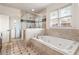 Luxurious bathroom featuring a glass enclosed shower and a soaking tub with tile surround at 629 Boulevard Ne, Atlanta, GA 30308