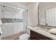 Bathroom featuring tile shower with glass door, granite countertops, and modern fixtures at 629 Boulevard Ne, Atlanta, GA 30308