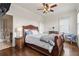 Cozy bedroom featuring wood floors, a ceiling fan, and an en-suite bathroom at 629 Boulevard Ne, Atlanta, GA 30308