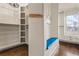 Walk-in closet featuring custom shelving and a cozy blue bench with views of the city at 629 Boulevard Ne, Atlanta, GA 30308