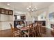 Dining room with dark wood floors, chandelier, and an open view into the adjacent kitchen area at 629 Boulevard Ne, Atlanta, GA 30308