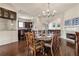 Dining room with dark wood floors, chandelier, and an open view into the adjacent kitchen area at 629 Boulevard Ne, Atlanta, GA 30308