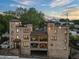 Multi-level brick apartment building with covered balcony and rooftop terraces overlooking the area at 629 Boulevard Ne, Atlanta, GA 30308