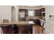 Open concept kitchen with stainless steel appliances, bar seating, tile backsplash and hardwood floors at 629 Boulevard Ne, Atlanta, GA 30308