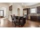 Kitchen with stainless steel refrigerator, dark wood cabinets, bar seating and archway entry at 629 Boulevard Ne, Atlanta, GA 30308