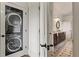 Hallway view with laundry and bathroom featuring a stackable washer and dryer at 629 Boulevard Ne, Atlanta, GA 30308