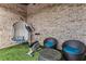 Covered patio featuring an exercise bike and seating area with brick wall backdrop at 629 Boulevard Ne, Atlanta, GA 30308
