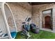 Covered patio with chair swing, exercise bike and seating adjacent to main house at 629 Boulevard Ne, Atlanta, GA 30308