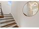Interior staircase with hardwood treads, white risers, and a round mirror on the wall at 629 Boulevard Ne, Atlanta, GA 30308