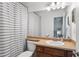 The bathroom has a vanity with wood cabinets, neutral countertops, and a framed mirror at 632 Plaza Se Dr # 6, Kennesaw, GA 30144