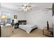 Cozy bedroom with neutral carpet, ceiling fan, and a window letting in natural light at 632 Plaza Se Dr # 6, Kennesaw, GA 30144