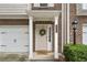 Inviting front porch with decorative wreath, manicured landscaping, and a convenient attached one-car garage at 632 Plaza Se Dr # 6, Kennesaw, GA 30144