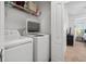 Convenient laundry room with modern washer and dryer; includes shelving for storage at 632 Plaza Se Dr # 6, Kennesaw, GA 30144