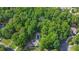 Aerial view of a home surrounded by lush greenery and featuring a private pool at 6455 Crystal Ln, Cumming, GA 30040