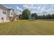Spacious backyard with a trampoline, accessed by stairs from the house at 6455 Crystal Ln, Cumming, GA 30040