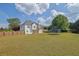 Wide view of backyard featuring trampoline, deck, and fenced yard at 6455 Crystal Ln, Cumming, GA 30040