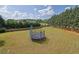 Expansive backyard featuring a trampoline and ample space for outdoor activities at 6455 Crystal Ln, Cumming, GA 30040