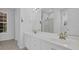 Bathroom featuring dual sinks, a large mirror, and an enclosed glass shower at 6455 Crystal Ln, Cumming, GA 30040