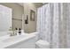 Bathroom featuring a toilet, sink and shower with a shower curtain at 6455 Crystal Ln, Cumming, GA 30040
