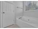 Bathroom featuring a soaking tub next to the window at 6455 Crystal Ln, Cumming, GA 30040
