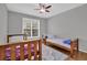 Neutral-toned bedroom featuring two beds and a window with natural light at 6455 Crystal Ln, Cumming, GA 30040