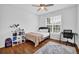 Bright bedroom featuring hardwood floors, a desk, and plenty of storage space at 6455 Crystal Ln, Cumming, GA 30040
