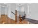 Welcoming foyer with hardwood floors, a shoe storage bench, and staircase, creating a stylish and organized entry at 6455 Crystal Ln, Cumming, GA 30040