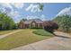 This home boasts a large front yard with a charming brick facade and perfectly trimmed landscaping at 6455 Crystal Ln, Cumming, GA 30040