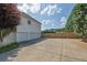 Spacious three-car garage with ample parking on a concrete driveway, framed by a privacy fence and mature evergreens at 6455 Crystal Ln, Cumming, GA 30040
