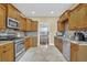 Spacious kitchen featuring stainless appliances, granite countertops, and a tile backsplash at 6455 Crystal Ln, Cumming, GA 30040