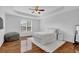 Spacious main bedroom with a tray ceiling, hardwood floors, and bright natural light at 6455 Crystal Ln, Cumming, GA 30040