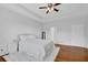 Bright main bedroom featuring tray ceilings, a ceiling fan and hardwood floors at 6455 Crystal Ln, Cumming, GA 30040