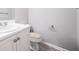 Bathroom features a white sink and cabinet with wood-look flooring at 7245 W Strickland St, Douglasville, GA 30134