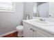 Cozy bathroom featuring white fixtures and warm wood floors at 7245 W Strickland St, Douglasville, GA 30134