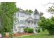 Charming home with white siding, classic architecture, and lush green landscaping at 7245 W Strickland St, Douglasville, GA 30134